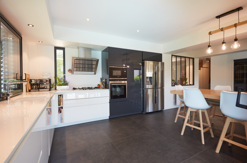 Design ideas for a medium sized contemporary grey and white l-shaped open plan kitchen in Lyon with a double-bowl sink, beaded cabinets, white cabinets, granite worktops, stainless steel appliances, terracotta flooring, no island, grey floors and white worktops.