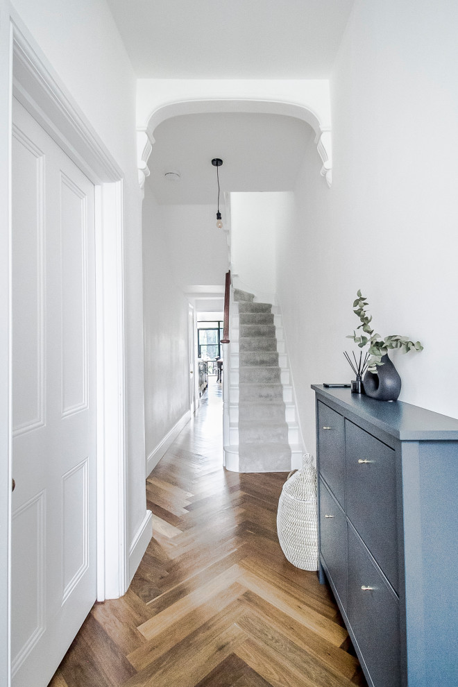 Idées déco pour une entrée classique de taille moyenne avec un couloir, un mur blanc, un sol en bois brun, une porte simple, une porte grise, un sol marron et un plafond à caissons.