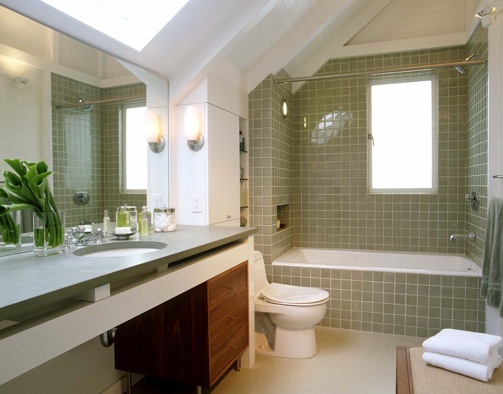 Photo of a transitional bathroom in San Francisco with an undermount sink, medium wood cabinets, an alcove tub, a shower/bathtub combo, beige tile and a shower curtain.