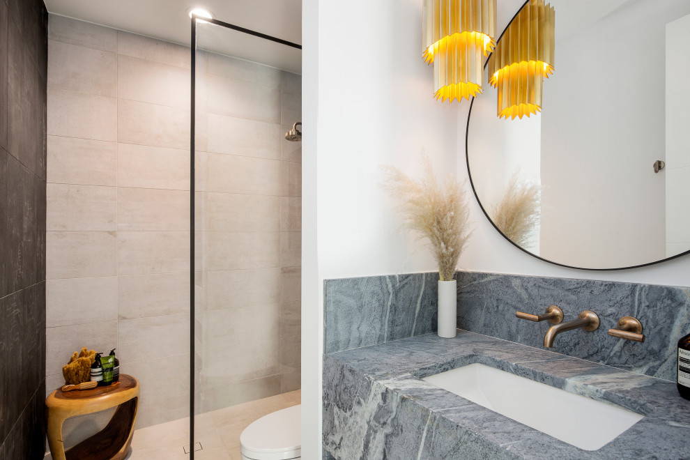 This is an example of a medium sized contemporary ensuite wet room bathroom in Denver with a one-piece toilet, white walls, a submerged sink, marble worktops, a sliding door, a single sink, a built in vanity unit, flat-panel cabinets, black cabinets and light hardwood flooring.