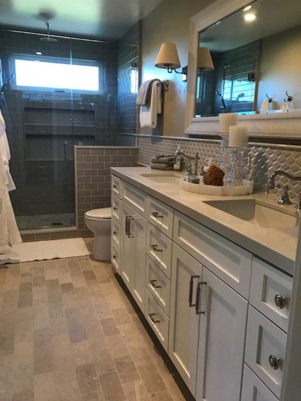 This is an example of a mid-sized traditional 3/4 bathroom in San Diego with recessed-panel cabinets, white cabinets, a corner shower, beige tile, glass tile, beige walls, brick floors, a drop-in sink, engineered quartz benchtops, beige floor and an open shower.