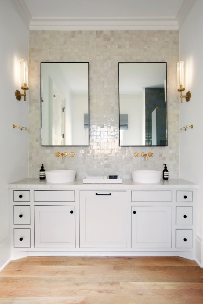 Design ideas for a transitional bathroom in Houston with shaker cabinets, white cabinets, beige tile, white walls, medium hardwood floors, a vessel sink, brown floor, white benchtops, a double vanity and a built-in vanity.