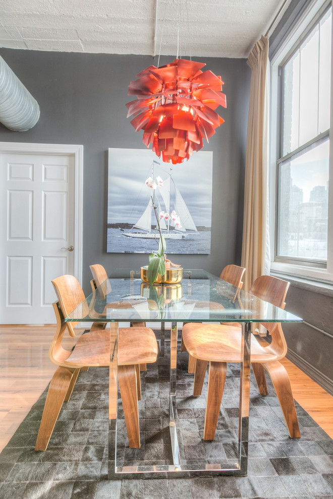 Photo of a mid-sized industrial open plan dining in Kansas City with grey walls and medium hardwood floors.