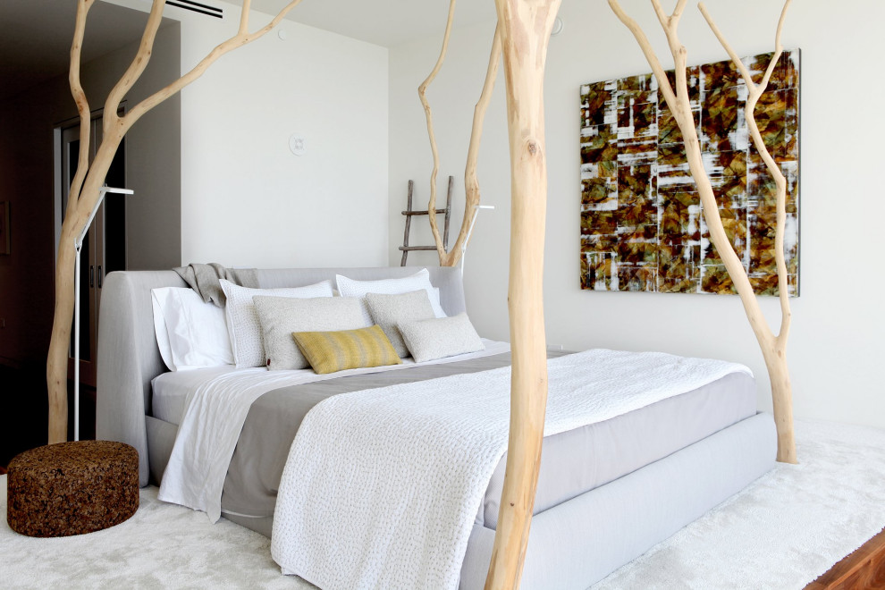 This is an example of a contemporary bedroom in Hawaii with white walls, carpet and white floor.