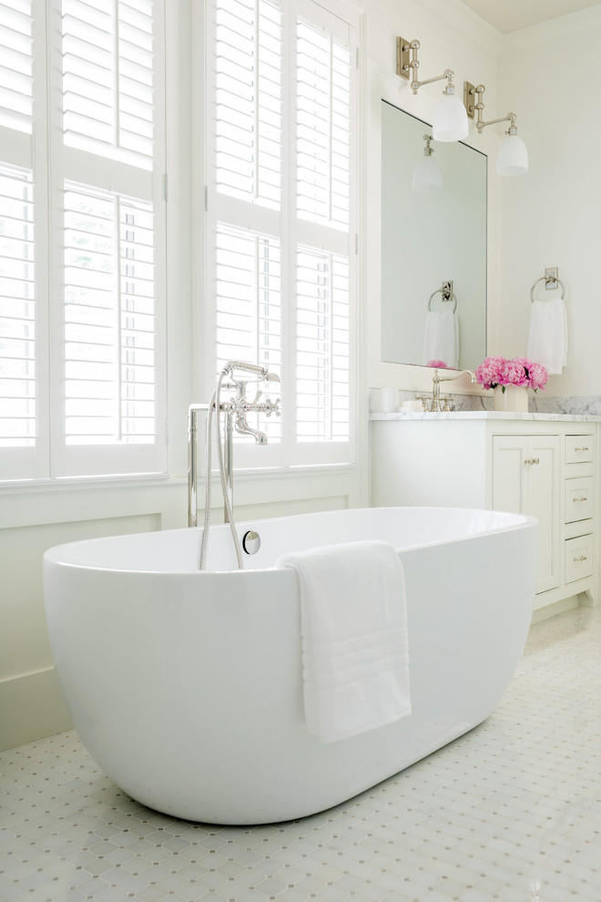 Inspiration for a mid-sized country master bathroom in Atlanta with flat-panel cabinets, white cabinets, a freestanding tub, an alcove shower, marble floors, white floor, a hinged shower door, white tile and white walls.