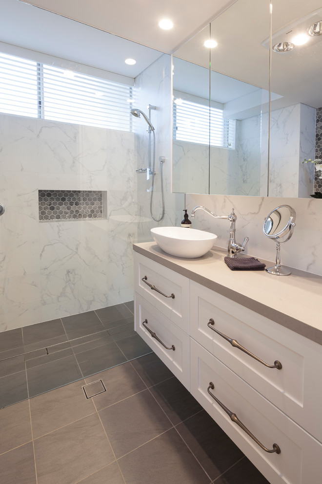 Design ideas for a mid-sized eclectic master bathroom in Sydney with shaker cabinets, white cabinets, a curbless shower, a wall-mount toilet, gray tile, porcelain tile, white walls, porcelain floors, a pedestal sink and engineered quartz benchtops.