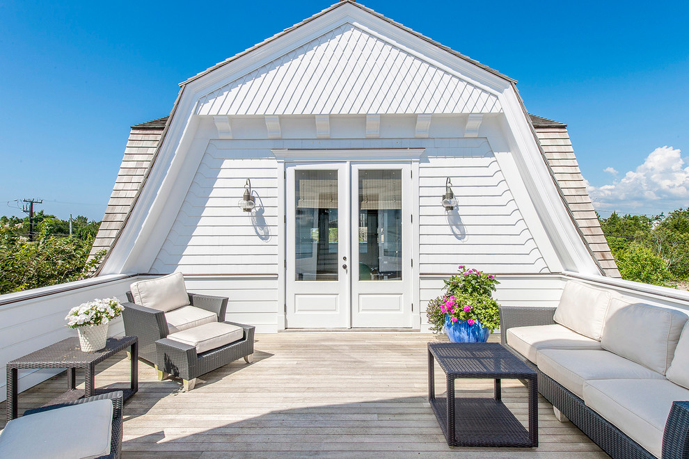 Example of a beach style deck design in New York with no cover