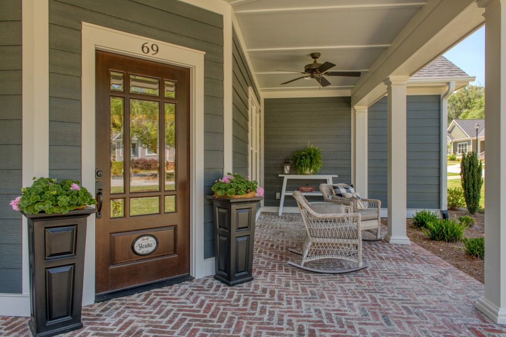 Design ideas for a medium sized traditional front veranda in Atlanta with with columns and brick paving.
