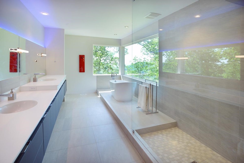 Design ideas for a mid-sized contemporary master bathroom in Nashville with flat-panel cabinets, a freestanding tub, white walls, an integrated sink, black cabinets, an alcove shower, gray tile, porcelain tile, concrete floors, grey floor and a hinged shower door.