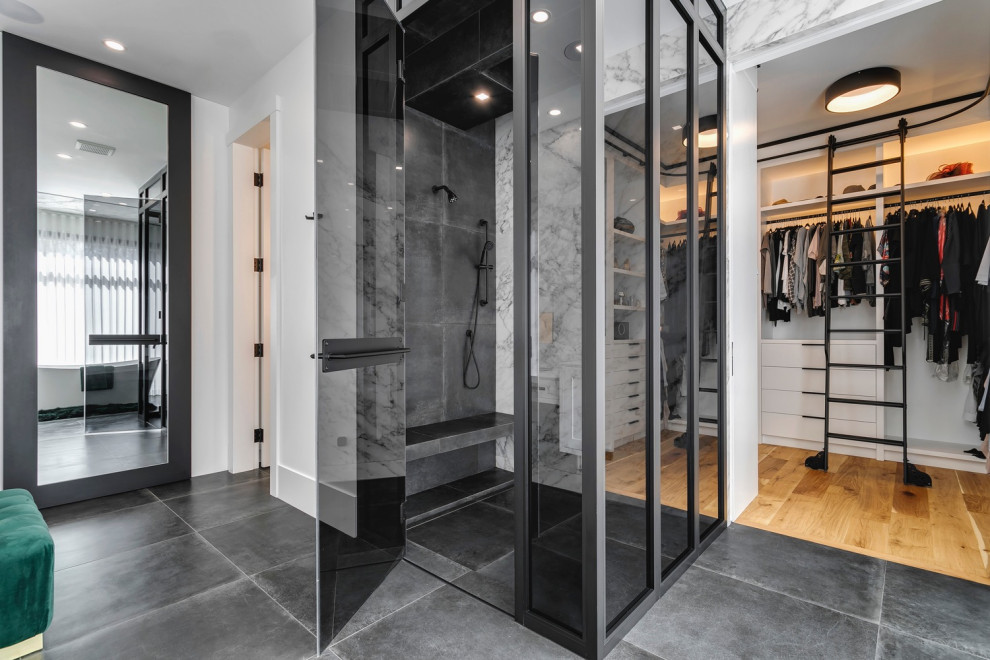 Photo of a large contemporary master bathroom in Calgary with recessed-panel cabinets, white cabinets, a freestanding tub, a curbless shower, black and white tile, porcelain tile, multi-coloured walls, porcelain floors, tile benchtops, black floor, a hinged shower door, white benchtops, a double vanity and a freestanding vanity.