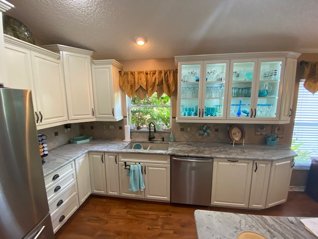 Inspiration for a large galley eat-in kitchen remodel with raised-panel cabinets, beige cabinets and an island