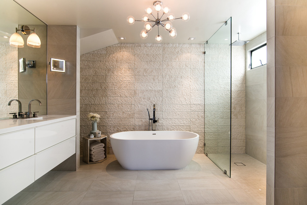 Photo of a small contemporary master bathroom in Los Angeles with flat-panel cabinets, white cabinets, a freestanding tub, an open shower, marble floors, an integrated sink, solid surface benchtops, beige floor, an open shower and white benchtops.