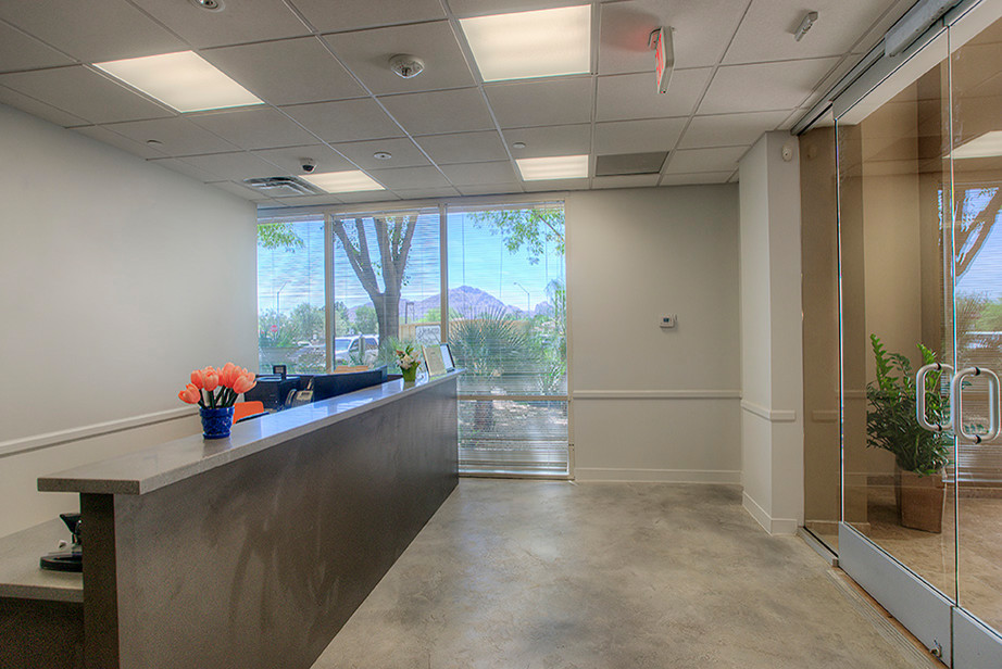 Entryway - mid-sized modern entryway idea in Phoenix with beige walls and a glass front door