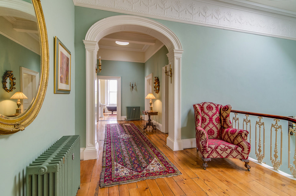 Design ideas for a large traditional hallway in Belfast with green walls and light hardwood floors.