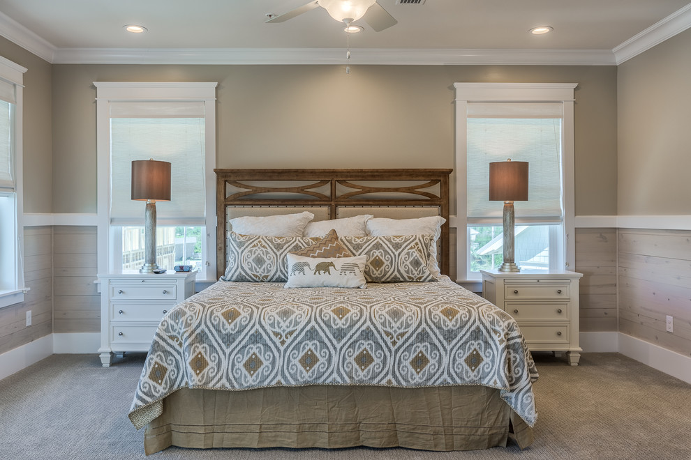 This is an example of a mid-sized beach style master bedroom in Miami with beige walls and carpet.