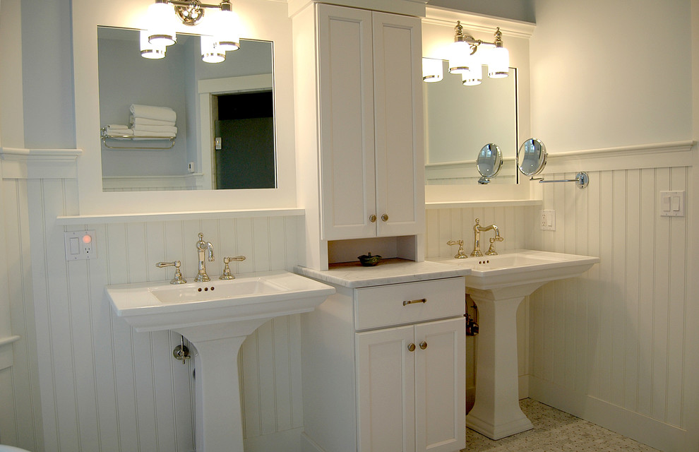 Mid-sized eclectic master bathroom in Portland Maine with shaker cabinets, white cabinets, blue walls, marble floors, a pedestal sink and granite benchtops.