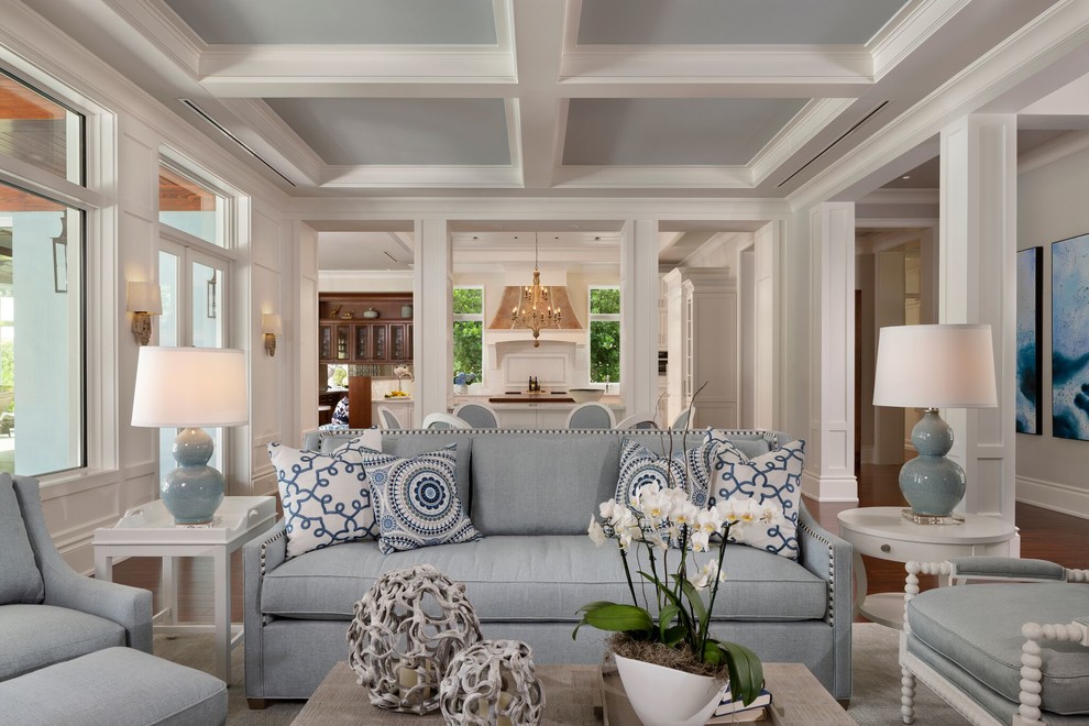 Inspiration for a mid-sized transitional open concept family room in Miami with white walls, medium hardwood floors, a standard fireplace, a tile fireplace surround, a built-in media wall and brown floor.