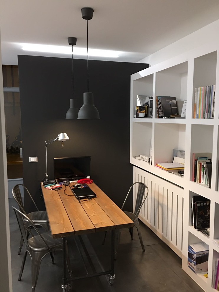 Photo of a small industrial home studio in Other with grey walls and a freestanding desk.