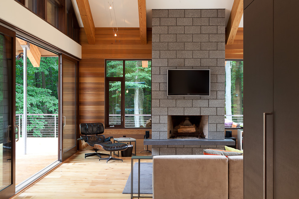 Photo of a contemporary living room in Grand Rapids with a standard fireplace and a wall-mounted tv.