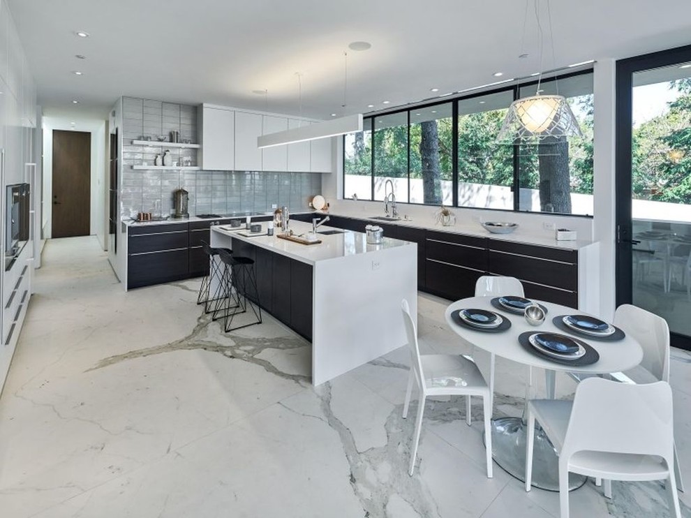 Design ideas for a large modern l-shaped open plan kitchen in Los Angeles with an undermount sink, flat-panel cabinets, white cabinets, quartzite benchtops, grey splashback, stainless steel appliances, marble floors, with island and white floor.