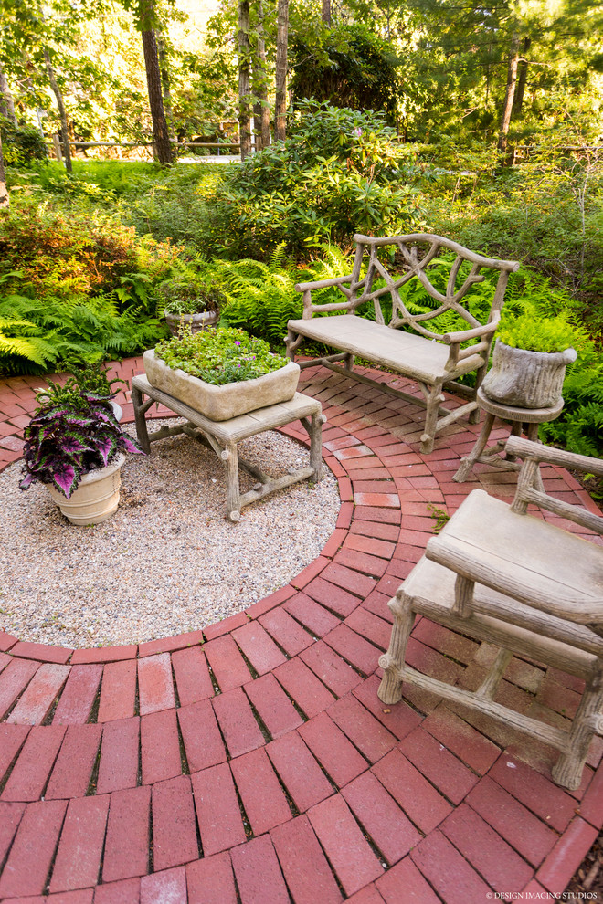 Photo of a small contemporary backyard patio in Boston with brick pavers and no cover.