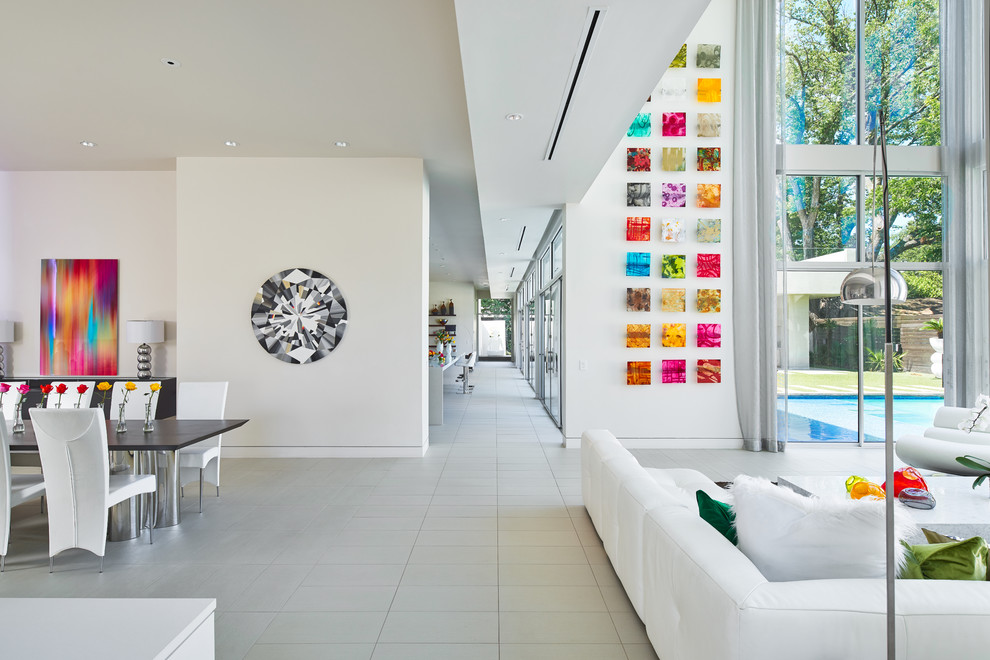 This is an example of an expansive modern hallway in Dallas with white walls, porcelain floors and white floor.