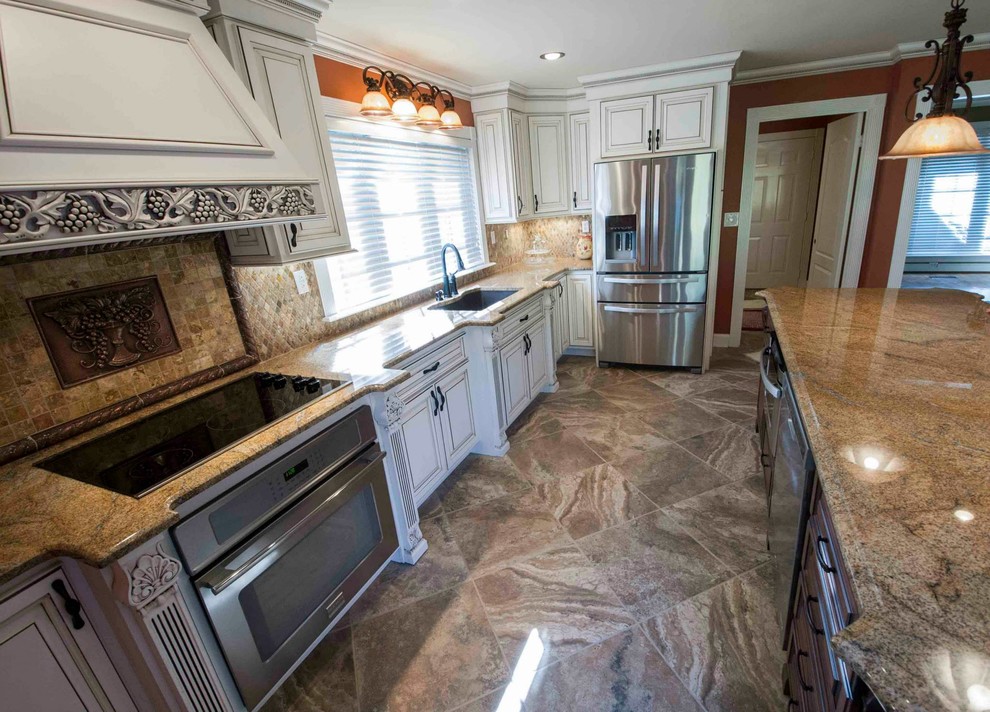Eat-in kitchen - large traditional porcelain tile and brown floor eat-in kitchen idea with an undermount sink, beaded inset cabinets, dark wood cabinets, granite countertops, multicolored backsplash, stone tile backsplash, stainless steel appliances and an island