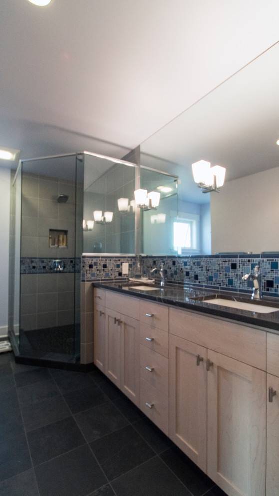 Inspiration for a large arts and crafts bathroom in Seattle with shaker cabinets, a corner shower, blue tile, gray tile, glass tile, grey walls, an undermount sink, light wood cabinets and slate floors.