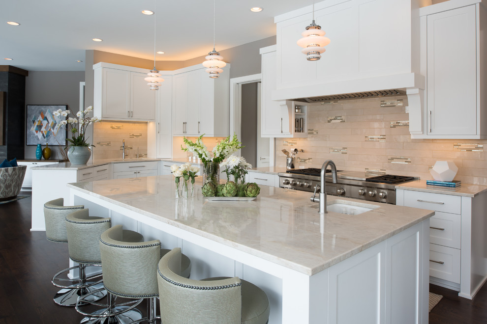 Photo of a transitional open plan kitchen in Minneapolis with an undermount sink, shaker cabinets, white cabinets, beige splashback, stainless steel appliances, dark hardwood floors and with island.
