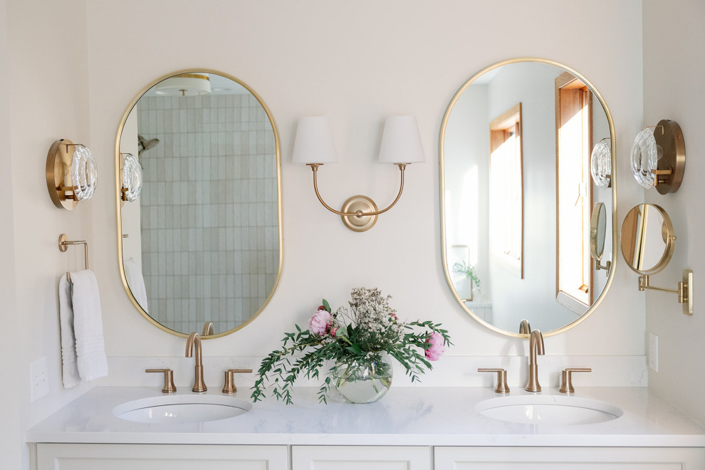 Freestanding bathtub - large transitional master white tile and porcelain tile porcelain tile, white floor and double-sink freestanding bathtub idea with shaker cabinets, white cabinets, white walls, an undermount sink, quartz countertops, a hinged shower door, white countertops, a niche and a built-in vanity