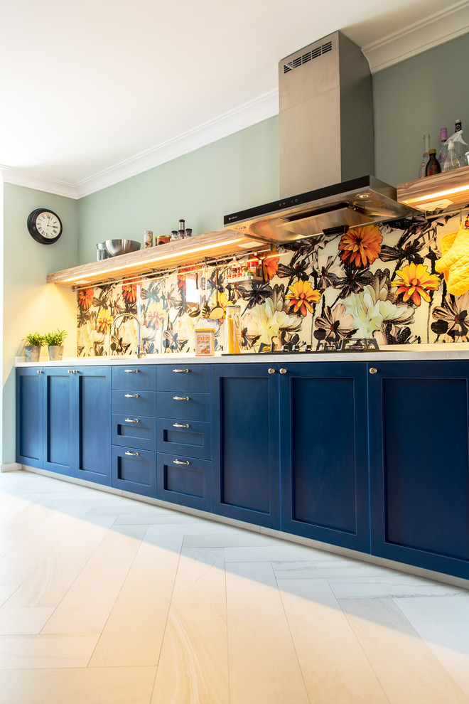 Inspiration for a mid-sized transitional galley separate kitchen in Singapore with a double-bowl sink, shaker cabinets, blue cabinets, quartzite benchtops, yellow splashback, glass sheet splashback, stainless steel appliances and porcelain floors.