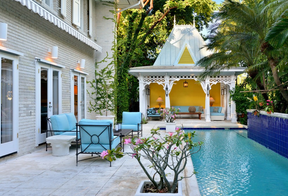 Photo of a traditional backyard pool in Tampa with a pool house.