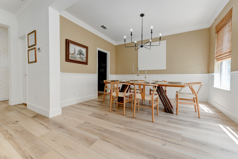 This is an example of an expansive transitional separate dining room in Austin with beige walls, vinyl floors, no fireplace, beige floor, recessed and wallpaper.