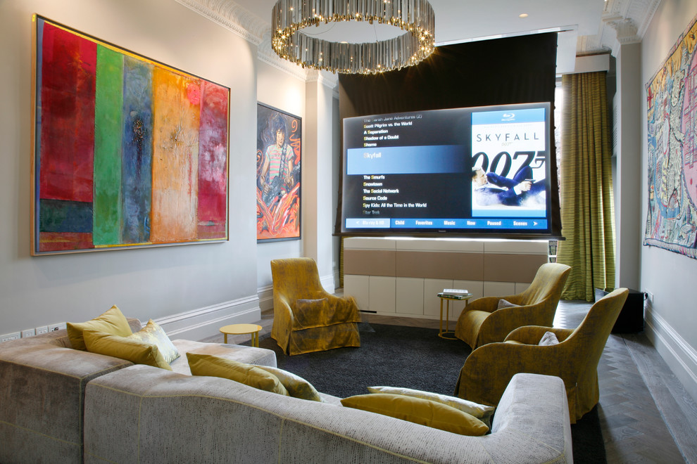 Mid-sized contemporary enclosed home theatre in London with grey walls and a projector screen.
