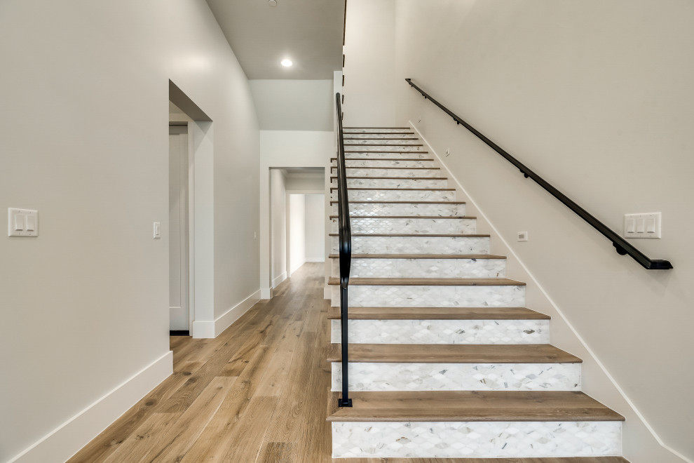 Inspiration for a mid-sized mediterranean wood straight staircase in Dallas with marble risers and metal railing.