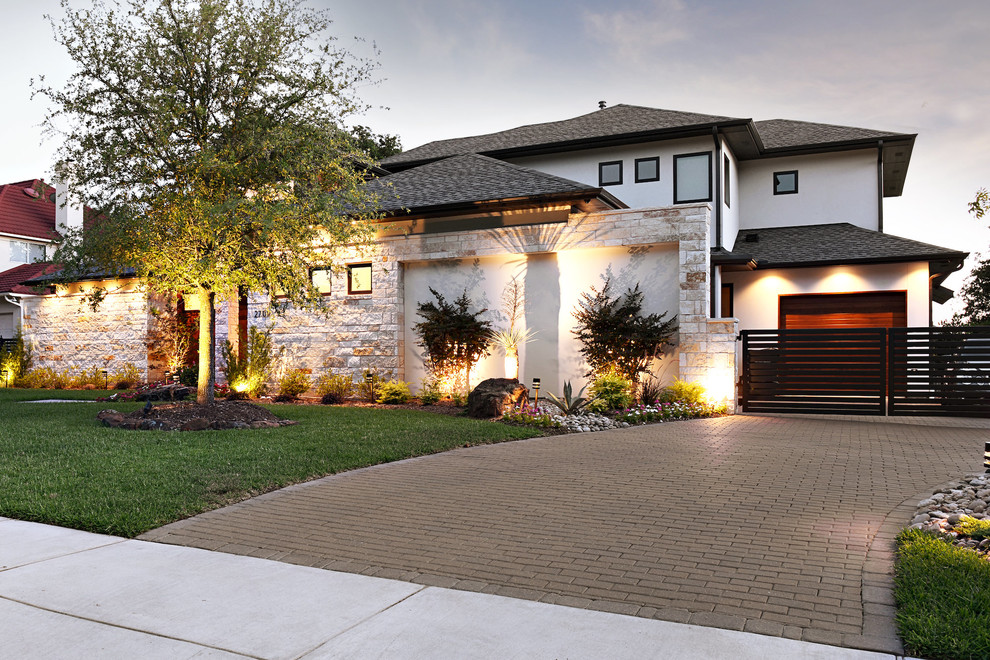 Inspiration for a mid-sized modern two-storey brown house exterior in Dallas with stone veneer and a shingle roof.