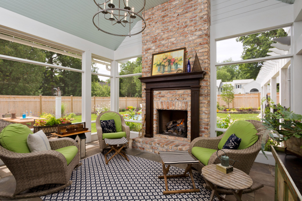 This is an example of a large traditional backyard verandah in New York with with fireplace and a pergola.