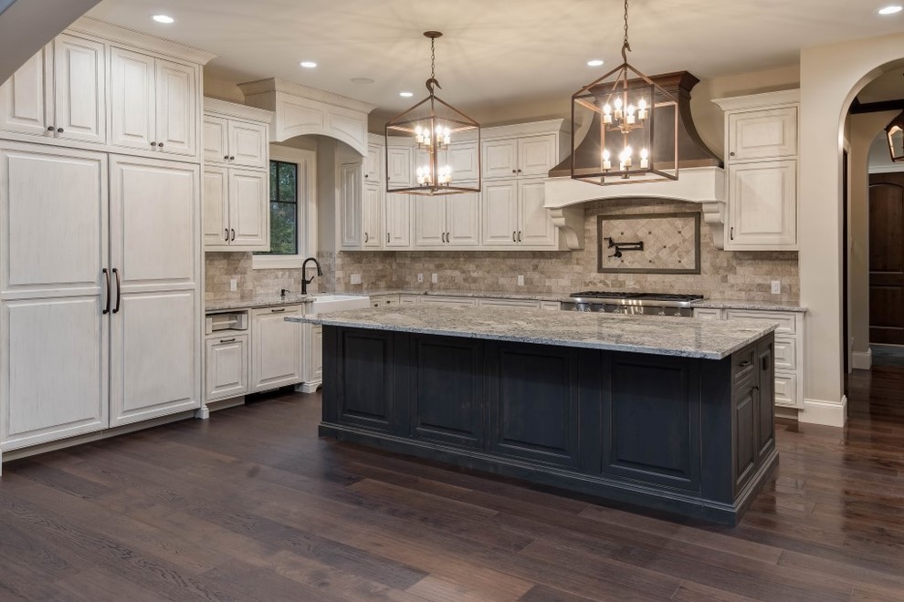 Design ideas for a large country l-shaped open plan kitchen in Other with a farmhouse sink, white cabinets, granite benchtops, beige splashback, stainless steel appliances, dark hardwood floors, with island and brown floor.
