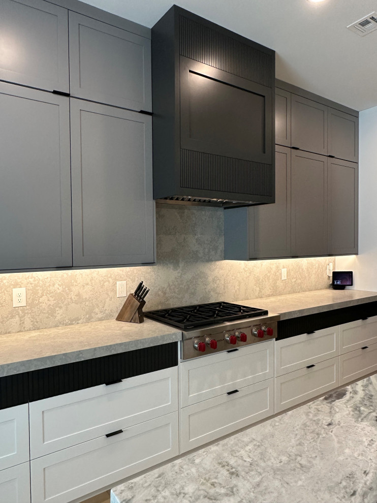 This is an example of a transitional single-wall kitchen in Las Vegas with shaker cabinets, white cabinets and with island.