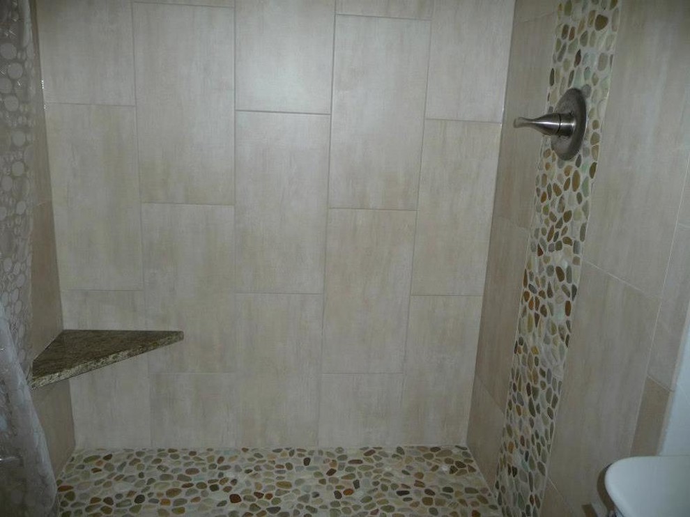 Alcove shower - mid-sized transitional master beige tile and porcelain tile pebble tile floor alcove shower idea in Milwaukee with white walls