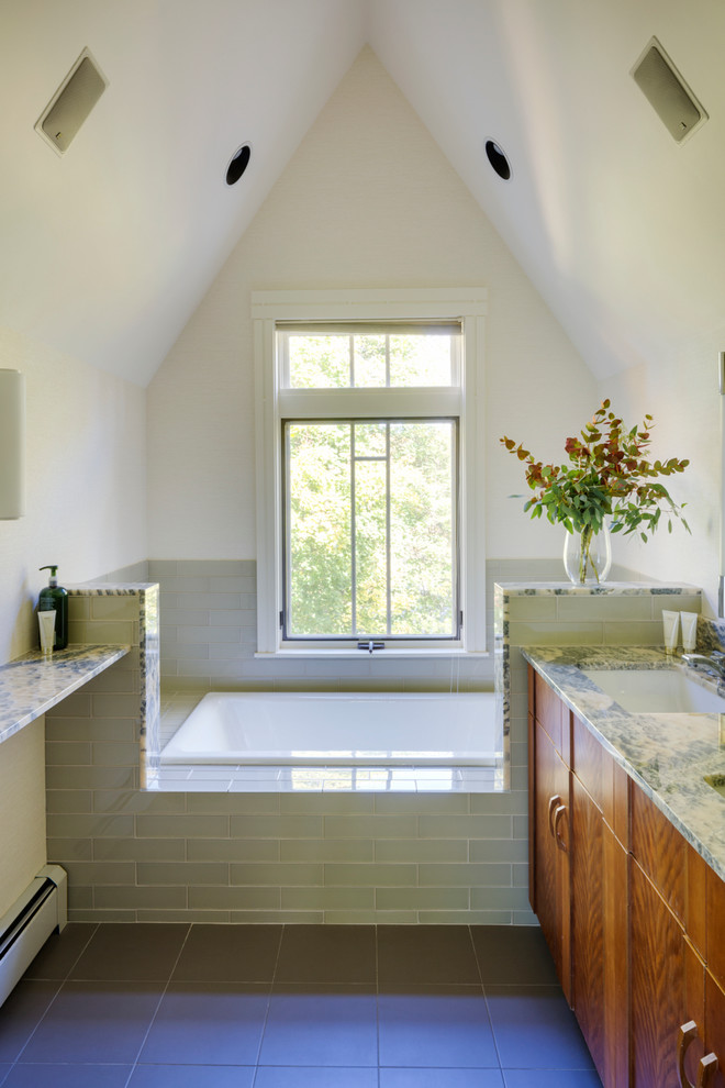 Design ideas for a mid-sized transitional master bathroom in Boston with an undermount sink, medium wood cabinets, onyx benchtops, a drop-in tub, an alcove shower, a two-piece toilet, beige tile, stone slab, beige walls and ceramic floors.