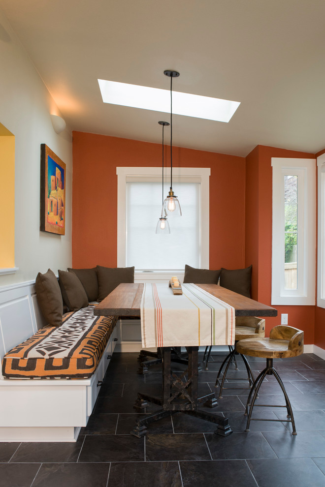 Inspiration for a contemporary dining room in Seattle with orange walls.