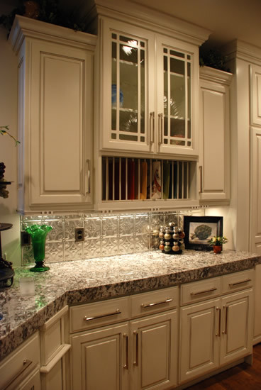 Mid-sized transitional u-shaped light wood floor enclosed kitchen photo in Salt Lake City with raised-panel cabinets, white cabinets, granite countertops, metallic backsplash, ceramic backsplash, stainless steel appliances and no island