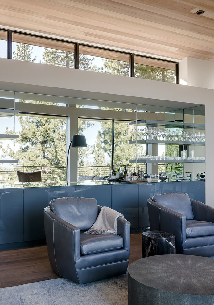 This is an example of a modern living room in San Francisco with a home bar and white walls.