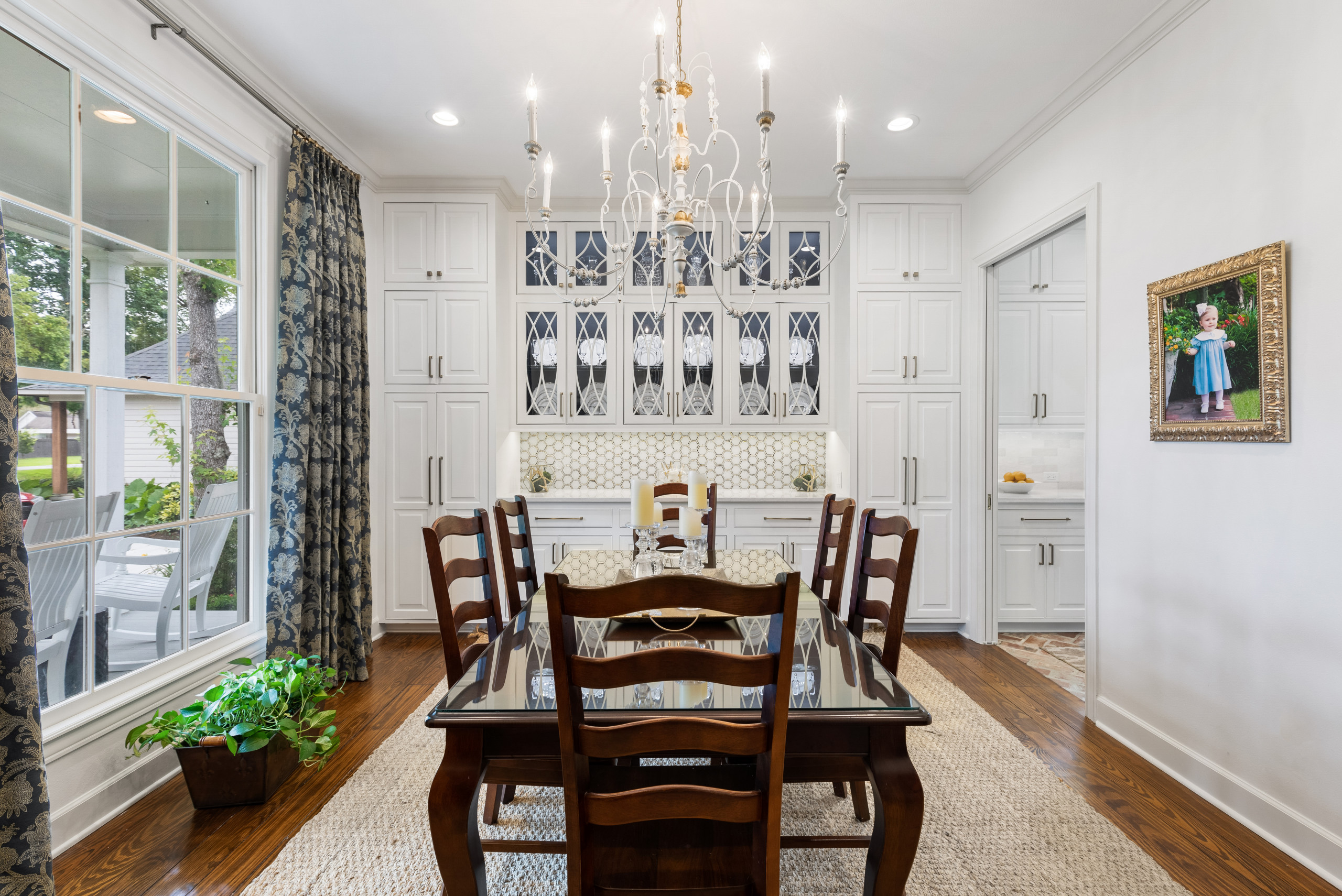 Example of a mid-sized classic dark wood floor and brown floor enclosed dining room design in New Orleans with gray walls