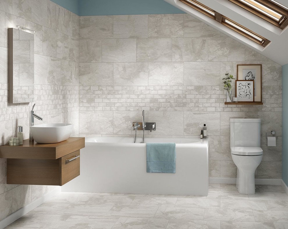 Inspiration for a mid-sized traditional master bathroom in Boise with porcelain floors, flat-panel cabinets, medium wood cabinets, a corner tub, a two-piece toilet, glass tile, beige walls, a vessel sink, wood benchtops and gray tile.