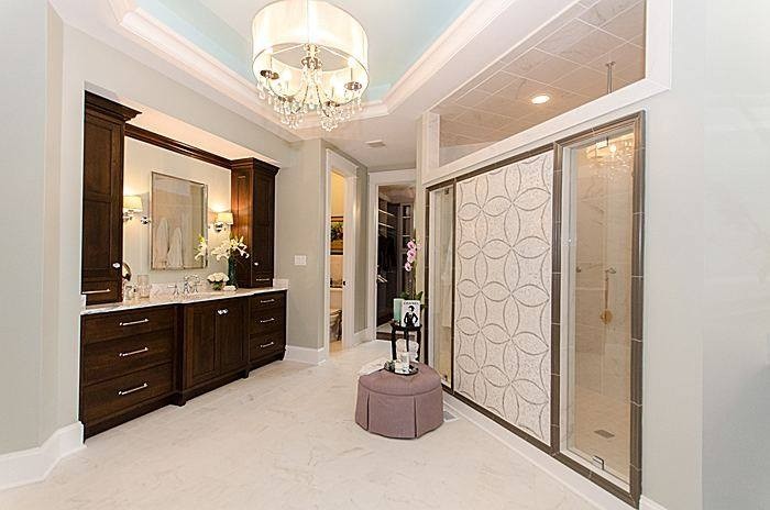 Design ideas for a large contemporary master bathroom in Richmond with recessed-panel cabinets, dark wood cabinets, a double shower, beige tile and beige walls.