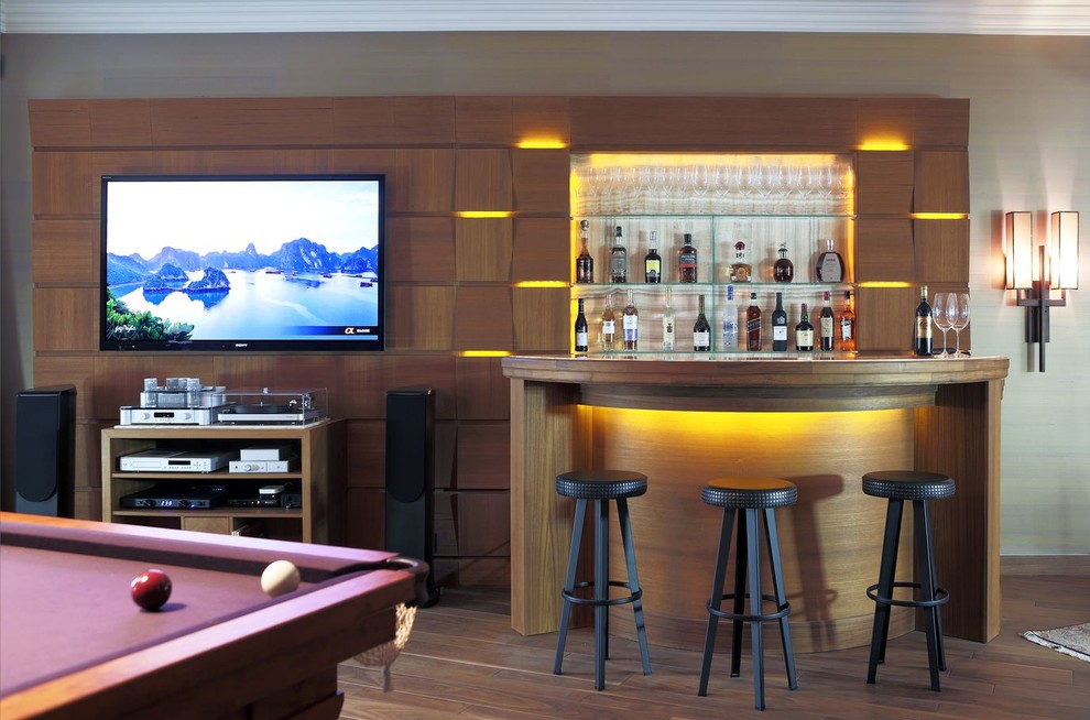 This is an example of a contemporary seated home bar in Moscow with medium hardwood floors, open cabinets and brown floor.