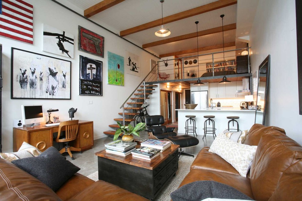 This is an example of an industrial open concept living room in Vancouver with no tv.