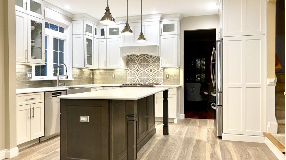 Design ideas for a large contemporary l-shaped eat-in kitchen in Seattle with a farmhouse sink, shaker cabinets, white cabinets, quartz benchtops, grey splashback, glass tile splashback, stainless steel appliances, light hardwood floors, with island, grey floor and multi-coloured benchtop.